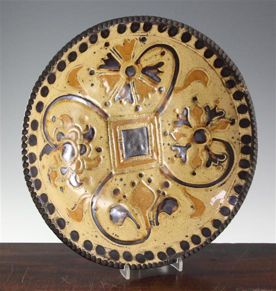 A Staffordshire slipware dish, c.1720-40, in the manner of Samuel Malkin (1668-1741) diameter 36cm (14.1in.)